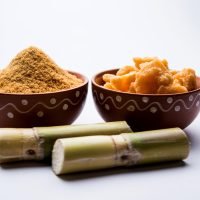 Organic Gur or Jaggery Powder is unrefined sugar obtained from concentrated sugarcane juice. served in a bowl. selective focus